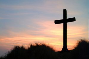 Cross at Sunset with dune grass in front of it